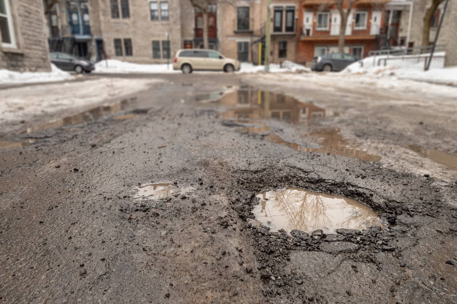 Large pothole in Montreal street, in Winter