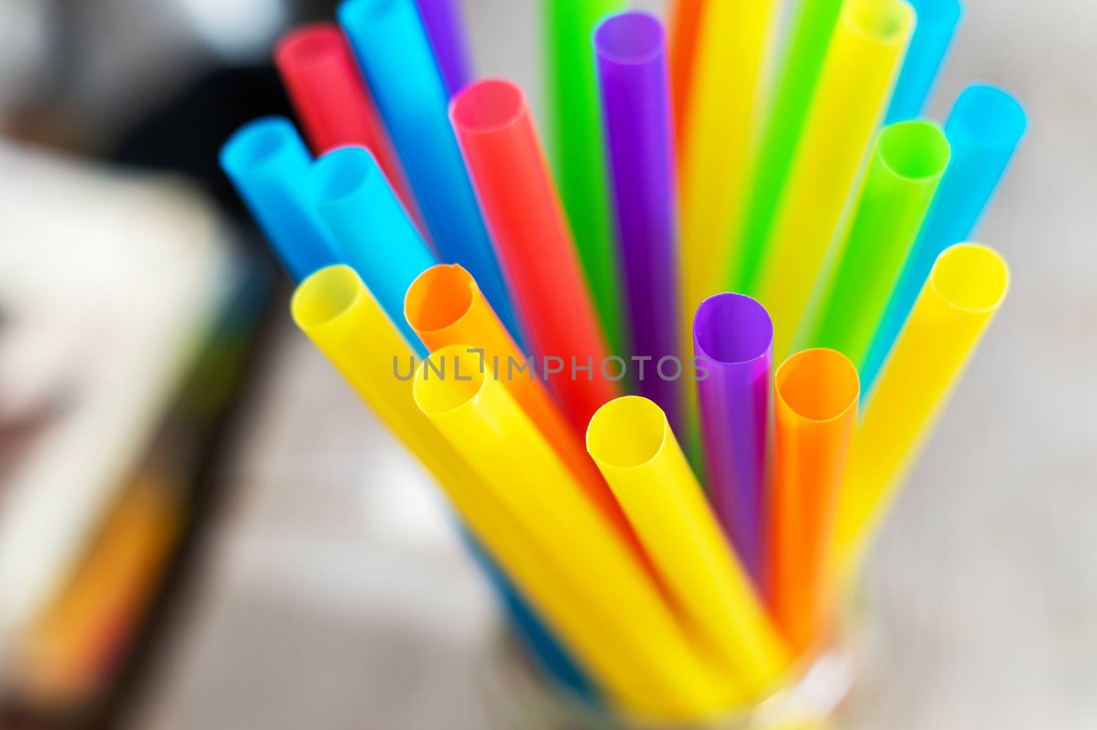 Top view of bright colorful plastic drinking straws and tubes