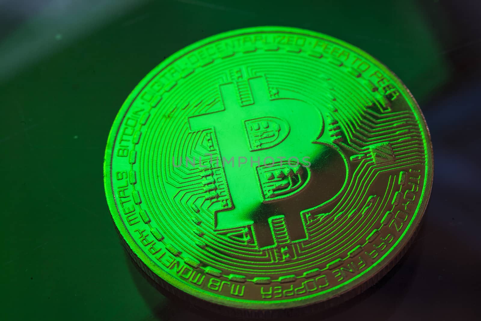 Green light on Bitcoin currency coin extreme close-up by adamr