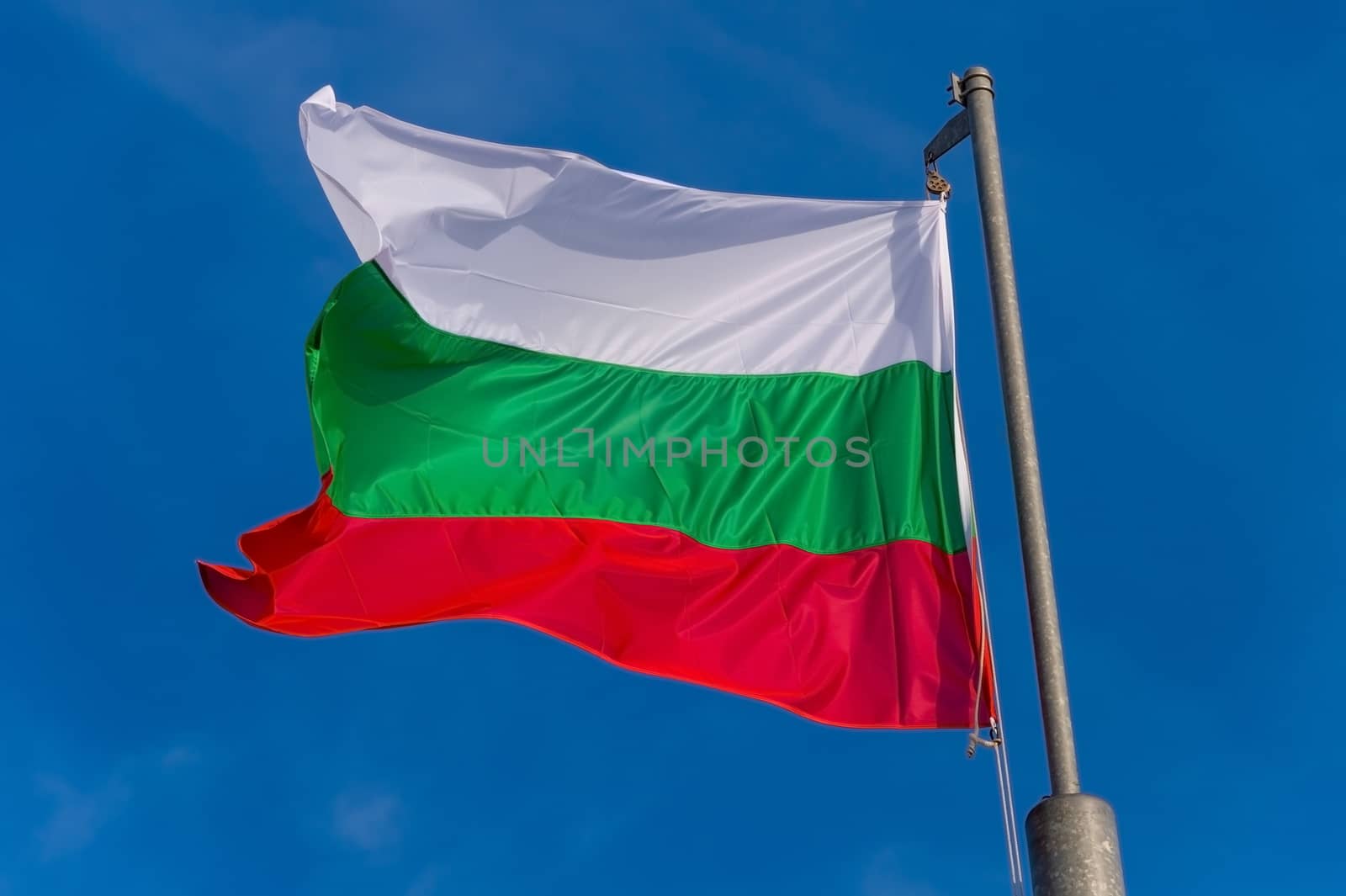 Bulgarian flag waving against blue sky in Boulogne sur Mer, France.