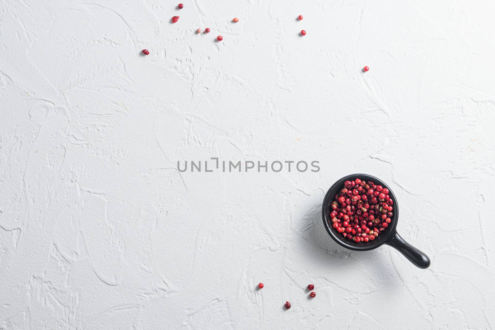 mediterranean diet concept texture peppercorn over white textured concrete background. space for text top view