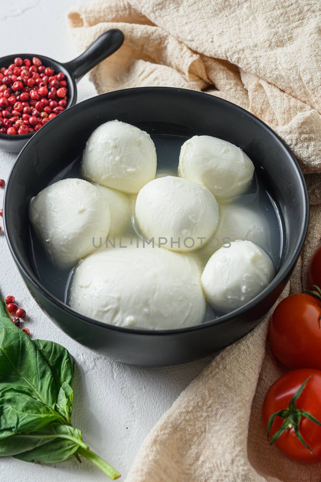 mozzarella buffalo, fresh basil, red tomatoes and olive oil. Italian cuisine, healthy lunch food. Italian caprese salad Ingredients . on cloth and white background. by Ilianesolenyi