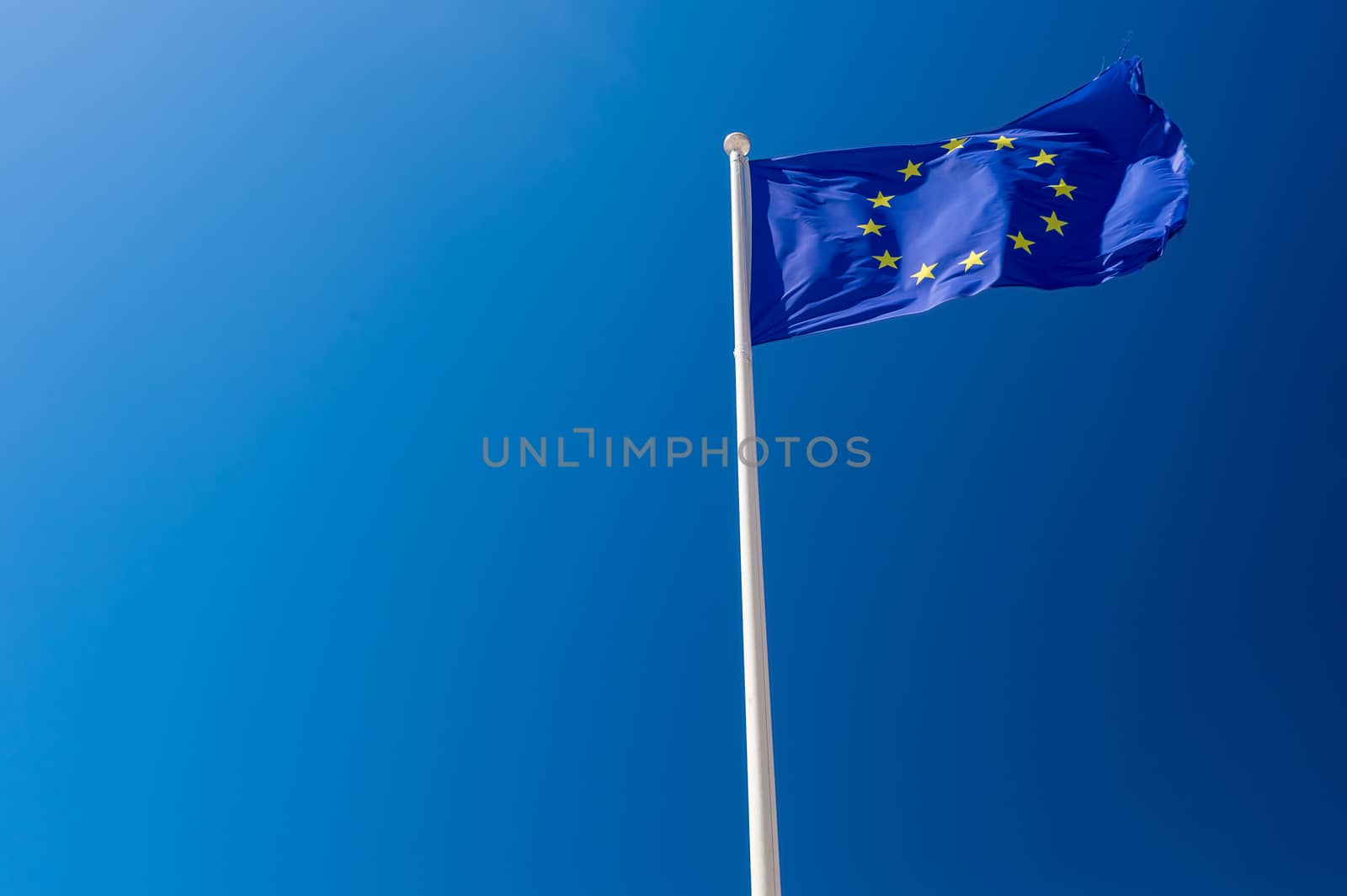 European flag waving against blue sky in Wimereux, France. by mbruxelle