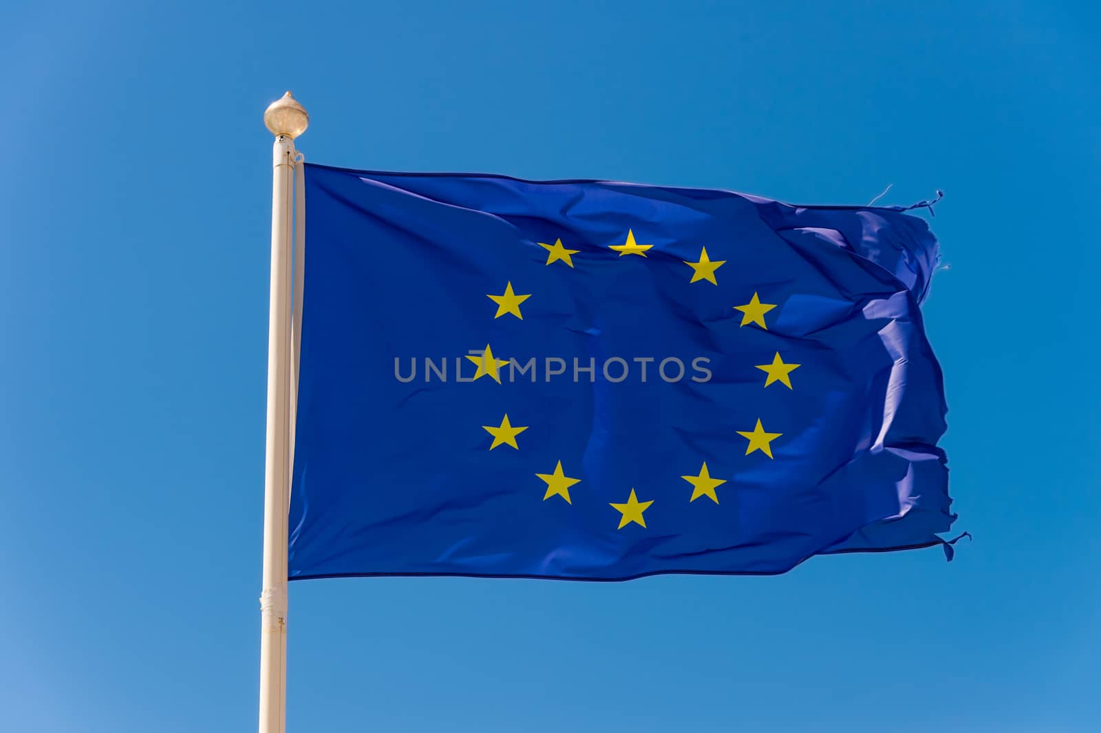 European flag waving against blue sky in Wimereux, France.