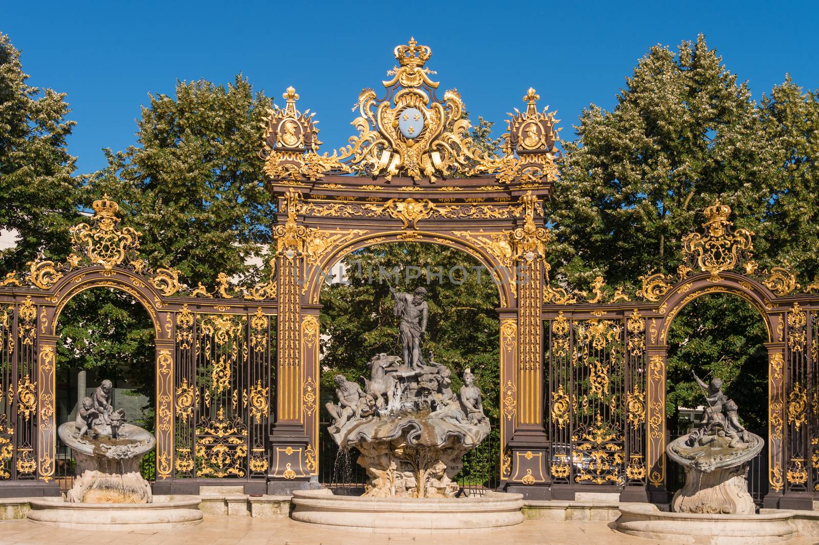 Nancy, France - 22 June 2018: Golden gate to the Place Stanislas square and Neptune Fountain in Nancy, France.