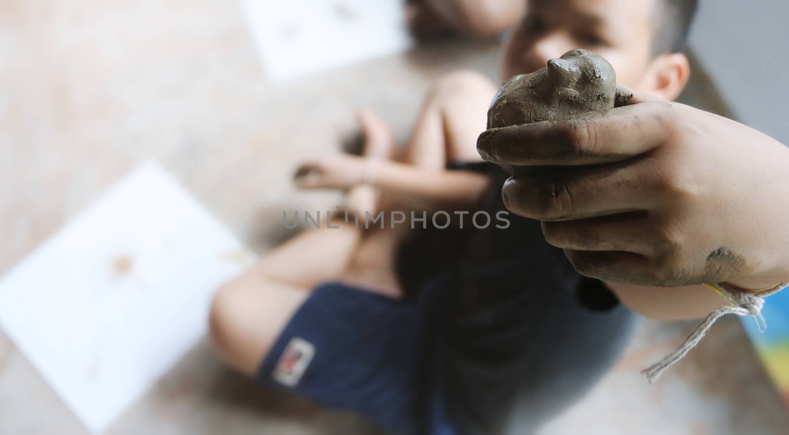 Child making a bird(dove ) from clay.Child creative activities,  by Chokchai