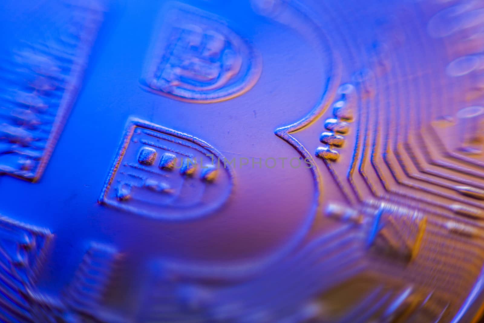 Bitcoin currency coin extreme closeup macro. Playing with color lights