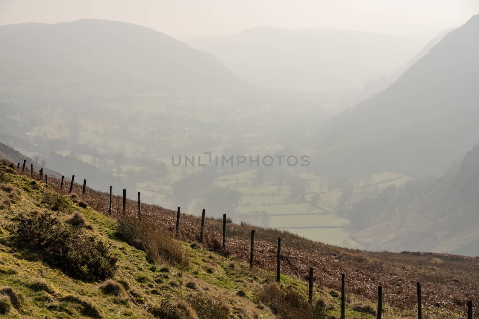 View besides road out of Llangynog in North Wales over the hills to Bala with misty valley behind