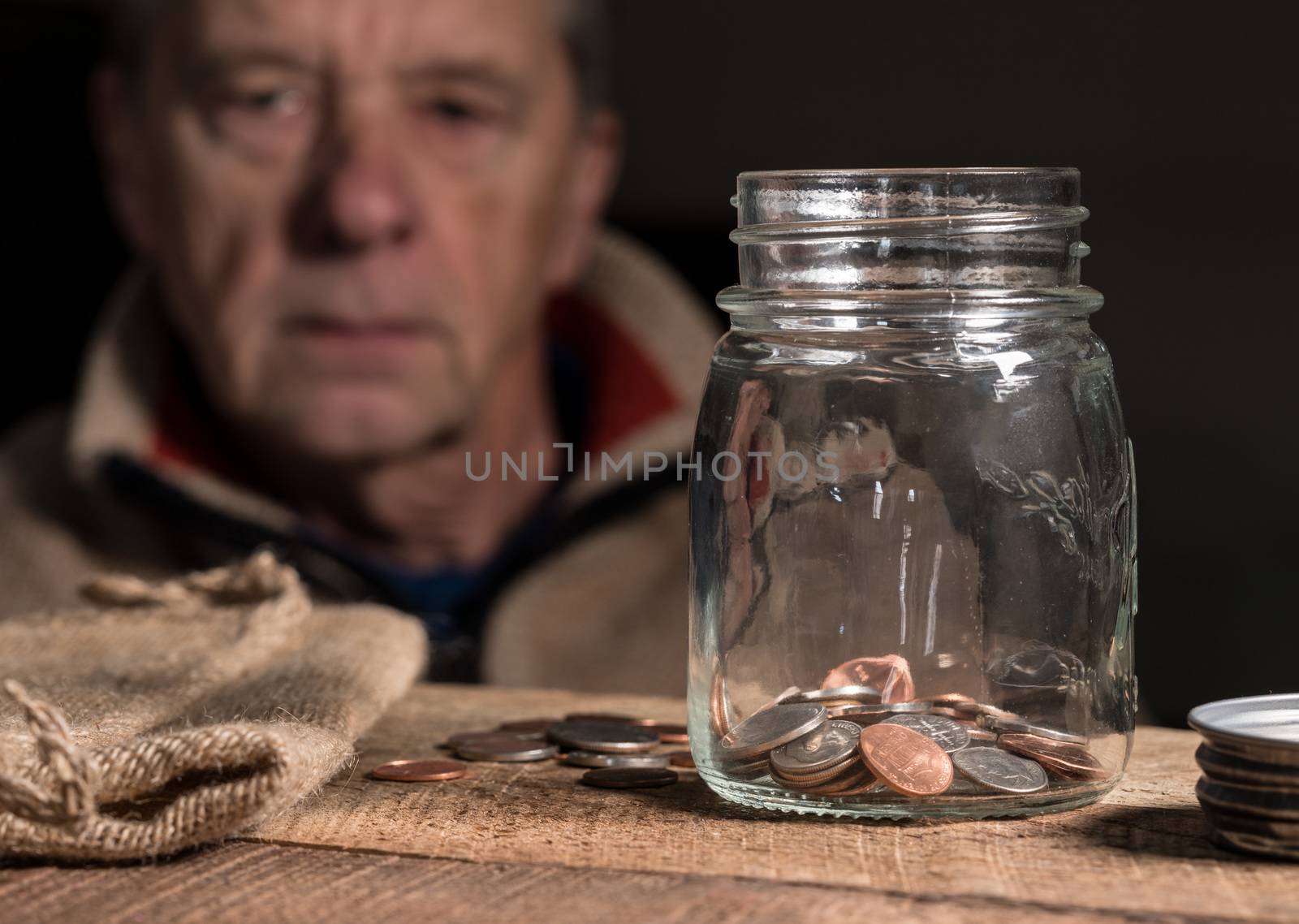 Senior retired caucasian man looking at remaining savings by steheap
