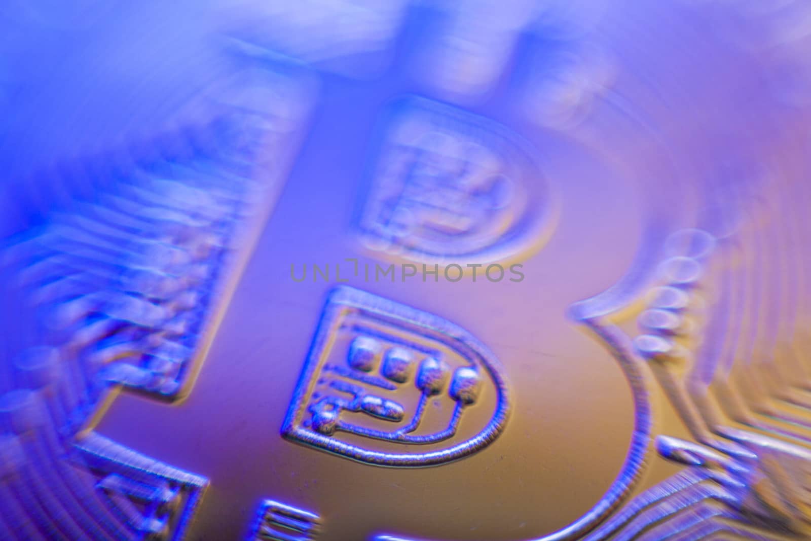 Cold and warm light on Bitcoin currency coin extreme close-up by adamr