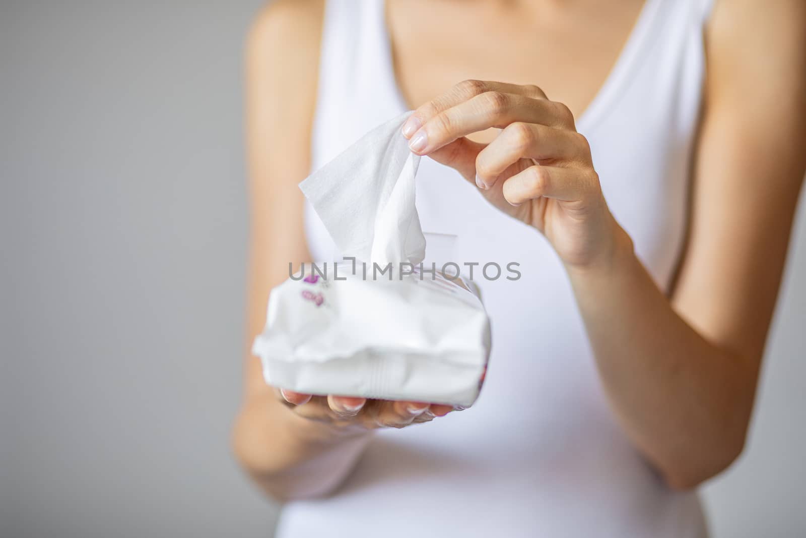 Wet wipes are universal an practical: woman take one wipe from big package for cleaning