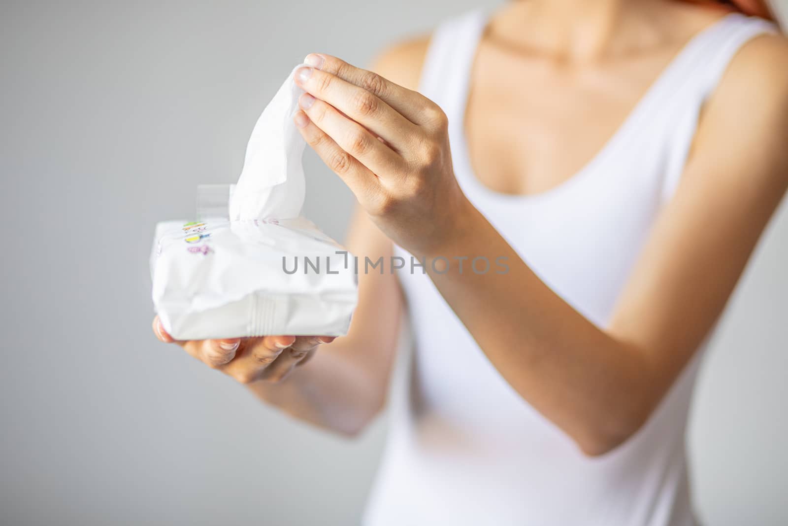 Wet wipes are universal an practical: woman take one wipe from big package for cleaning