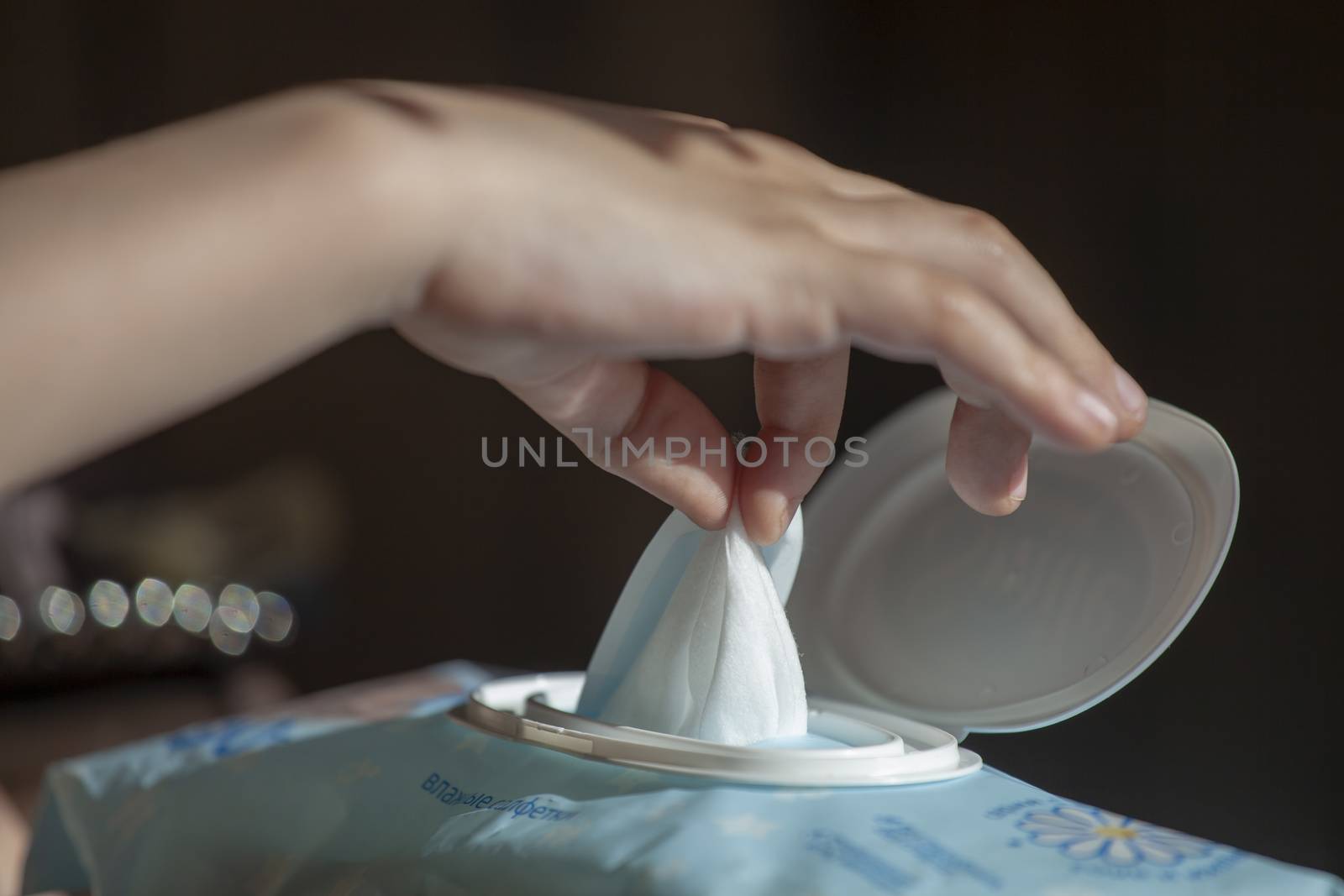 Hand picked a wet wipes from package box, Wet wipes in a children's hand