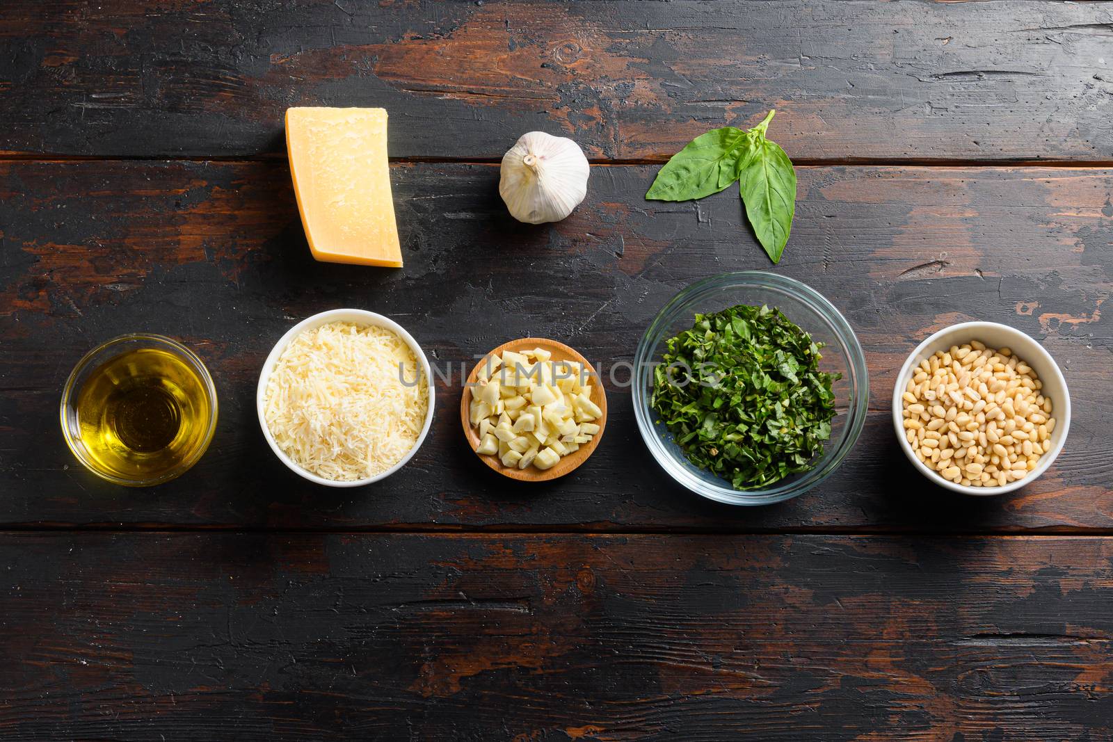 italian food background, healthy food concept or ingredients for cooking pesto sauce on a vintage wood background, top view with copy space.