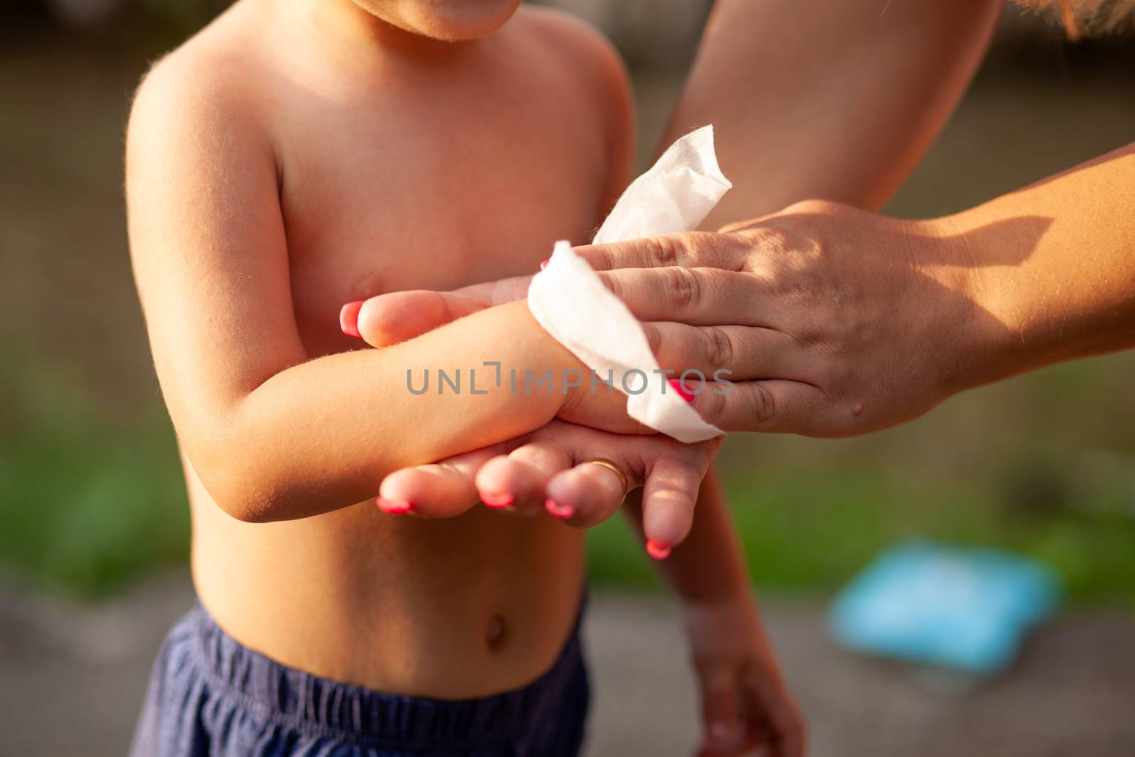 Hygiene - mom wiping the baby hands with wet wipes. Cleaning wipe, pure, clean, outdoor