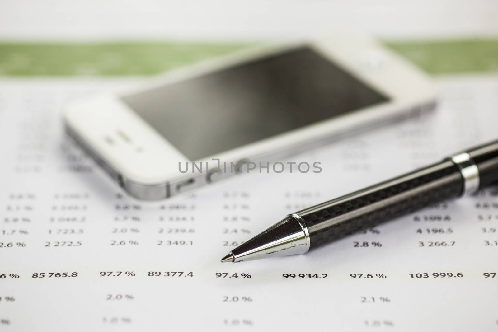 Business analysis - Accounting Calculating Cost Economic on office table. Pencil, chart on papper and bllured smartphone in background