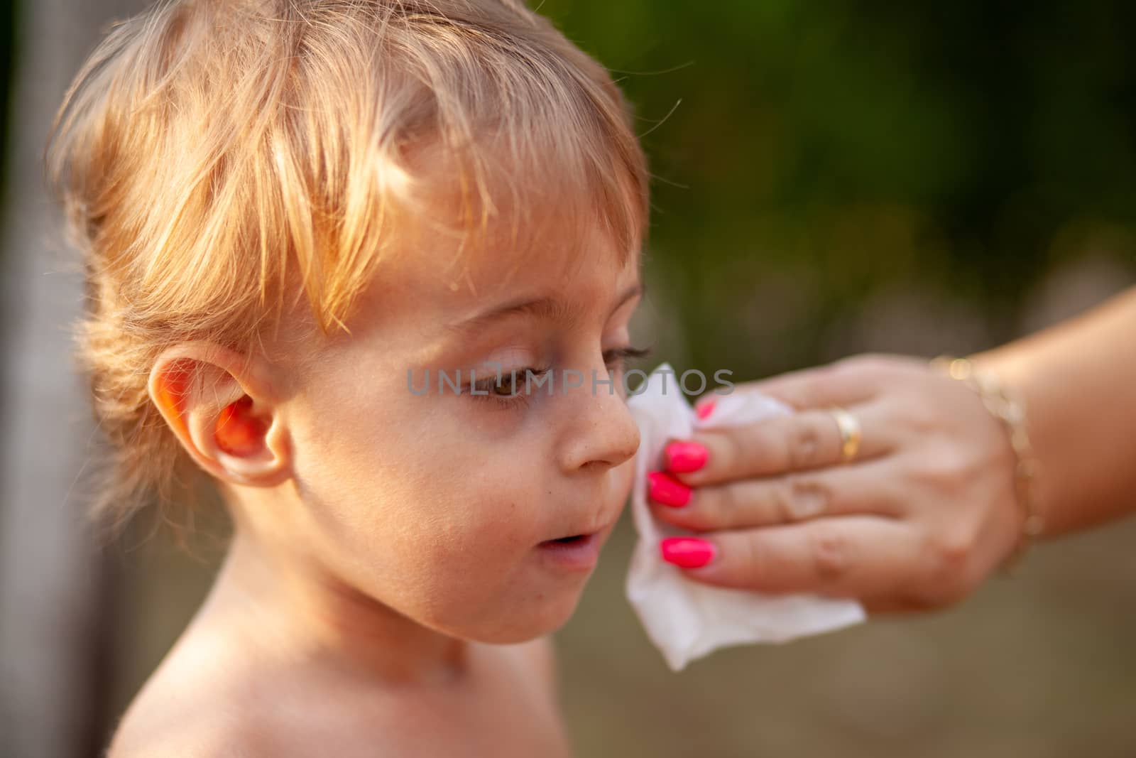 Hygiene - mom wiping the baby skin with wet wipes. Cleaning wipe, pure, clean, tissue, outdoor