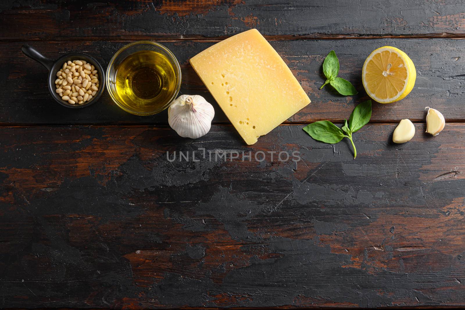 ingredients for pesto over wood planks background top view space for text.