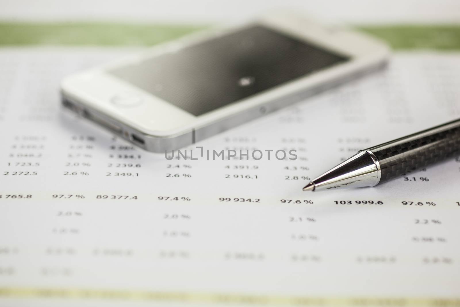 Business analysis - Accounting Calculating Cost Economic on office table. Pencil, chart on papper and bllured smartphone in background