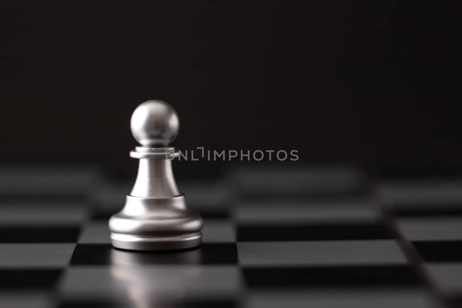 silver chip on the chessboard and black background