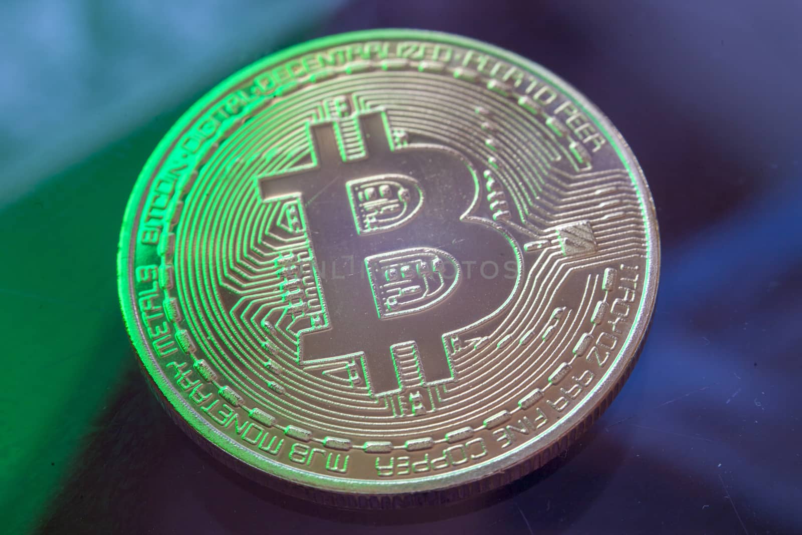 Green light on Bitcoin currency coin extreme close-up by adamr