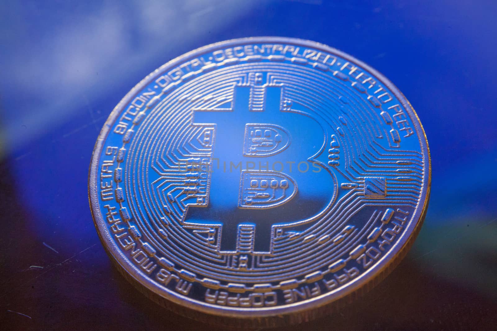 Blue Light On Bitcoin Currency Coin Extreme Close-up by adamr