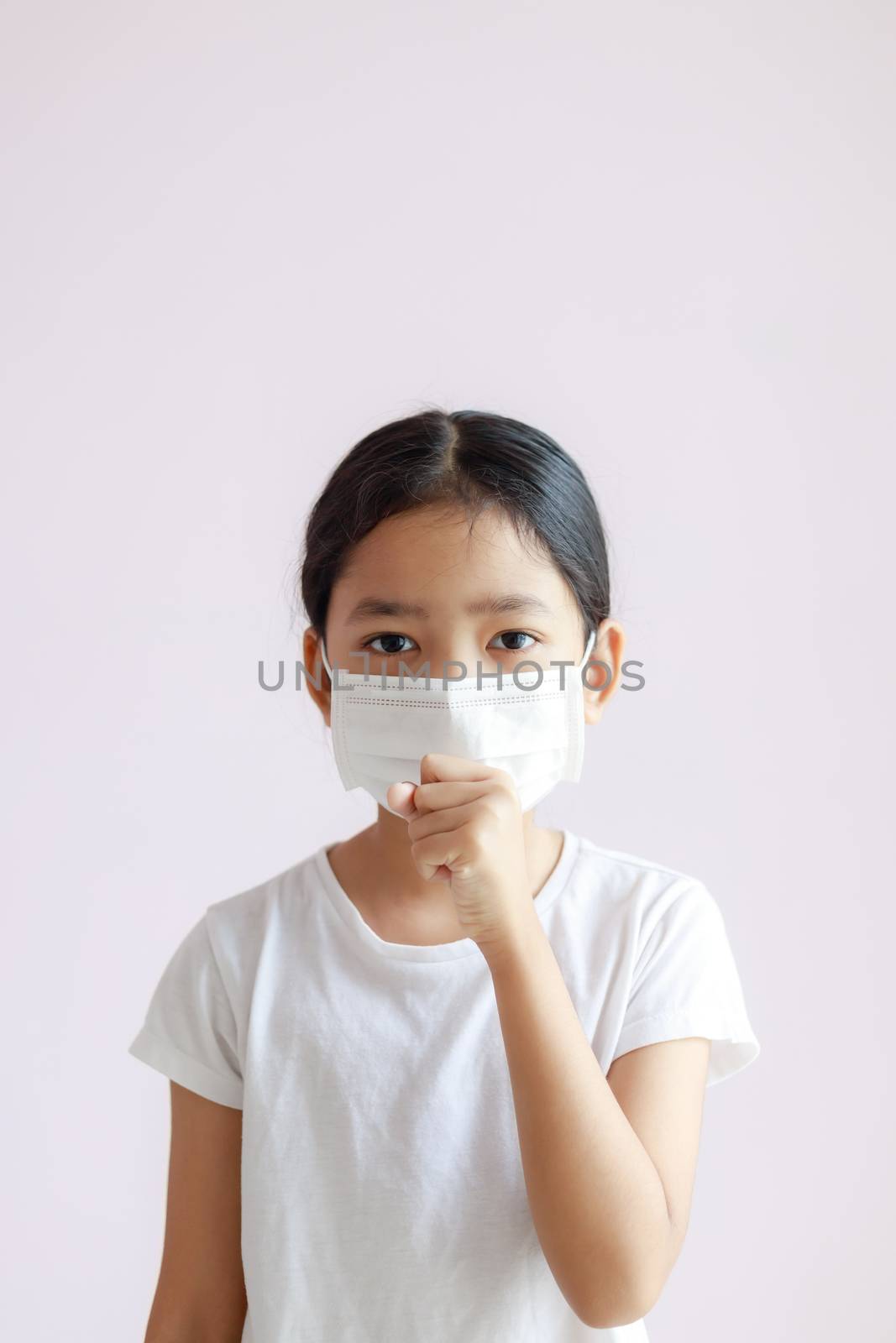 Portrait of Asian little girl wears a sanitary mask and coughs. The epidemic of the flu, Coronavirus or COVID-19 and illness with smog.