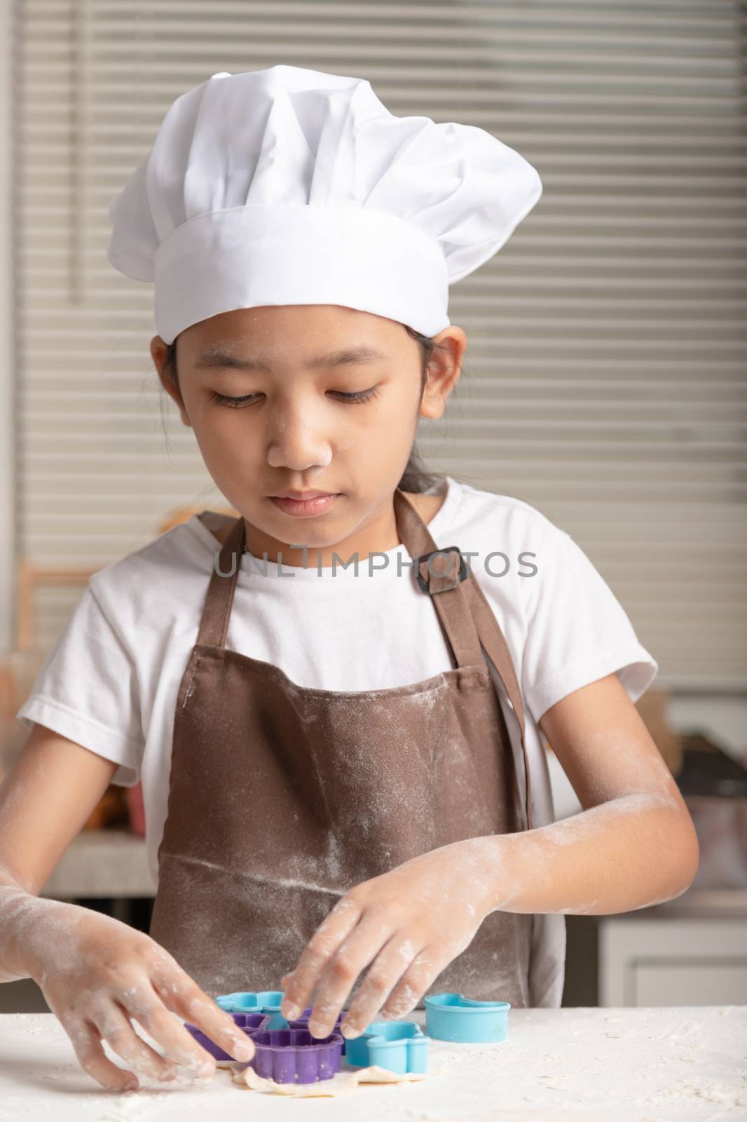 The little girl making cookies in the kitchen. by Nikkikii