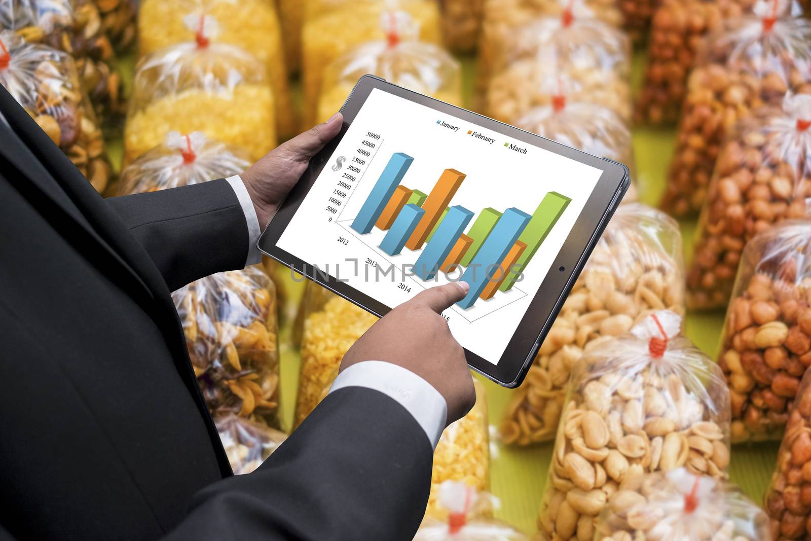 Business man doing agricultural business  on the screen of a touch-pad
