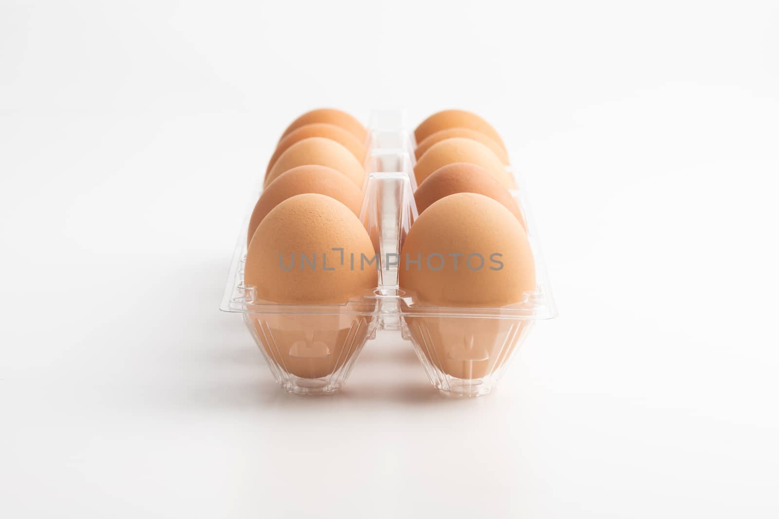 Eggs in a clear box on the white background.