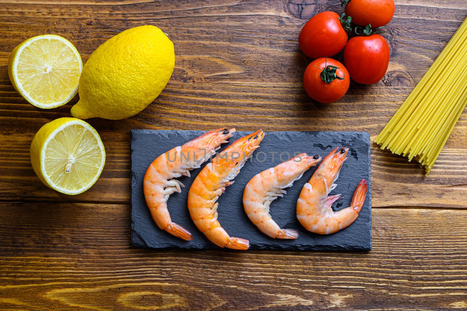 Lemon Garlic Shrimp with Spaghetti Ingredients classic recipe on wood table, top view by Ilianesolenyi