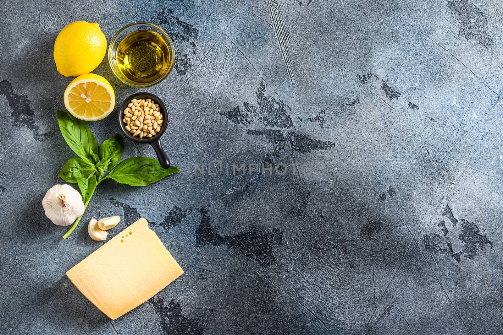italian ingredients for pesto genovese sauce background, healthy food concept on a vintage stone grey background Basil, olive oil, parmesan, garlic, pine nuts. Top view with copy space by Ilianesolenyi