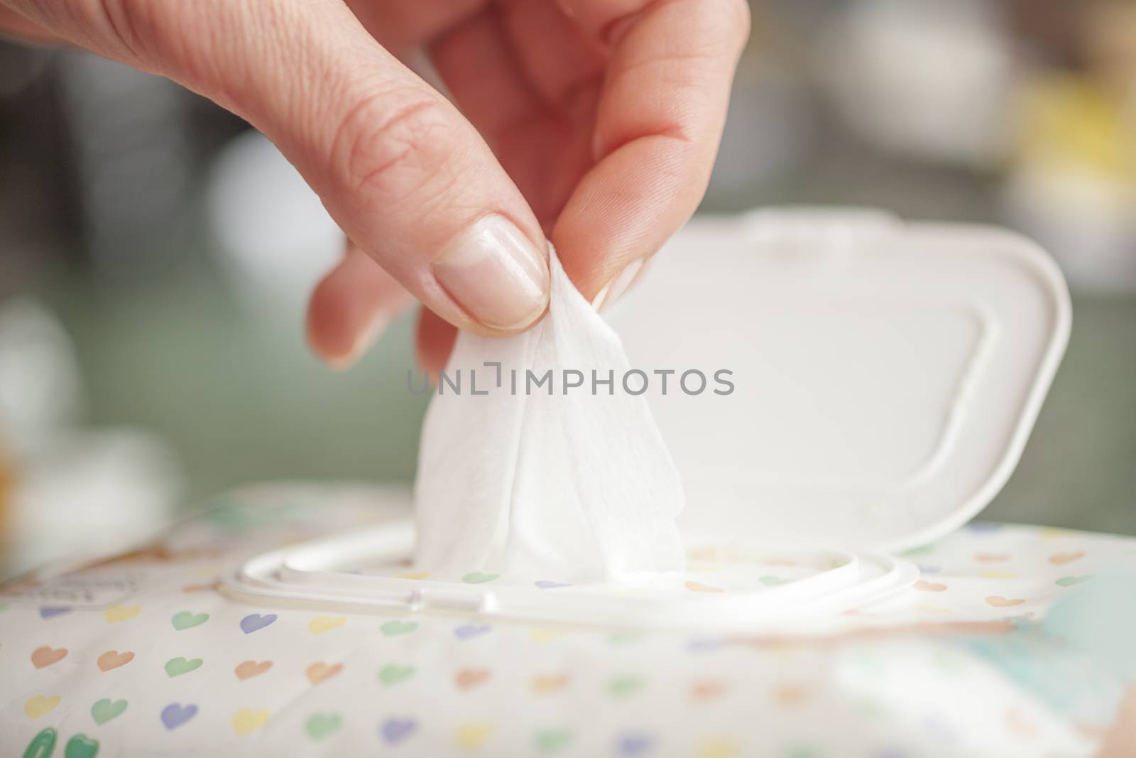 Hand picked a wet wipes in package box, Wet wipes in a woman's hand