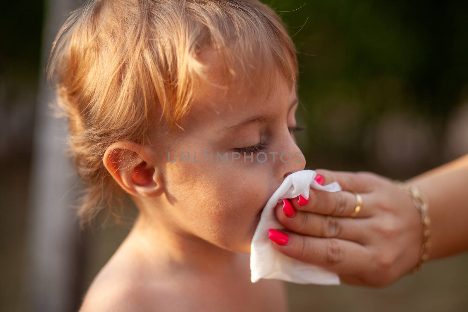 Cleaning baby face and skin with wet wipes tissue by adamr