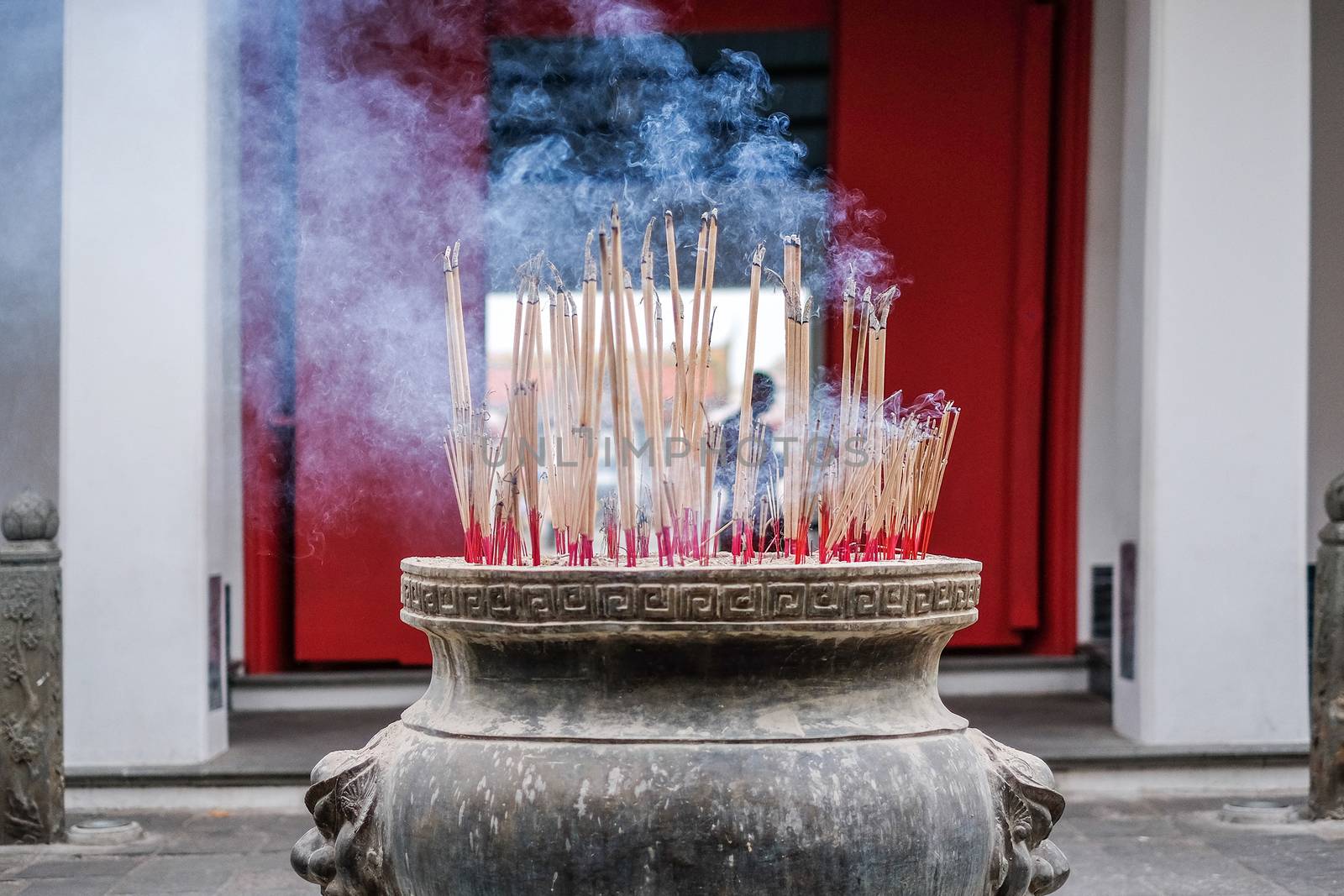 Incense sticks in ashes bucket in Temple Thialand by Surasak