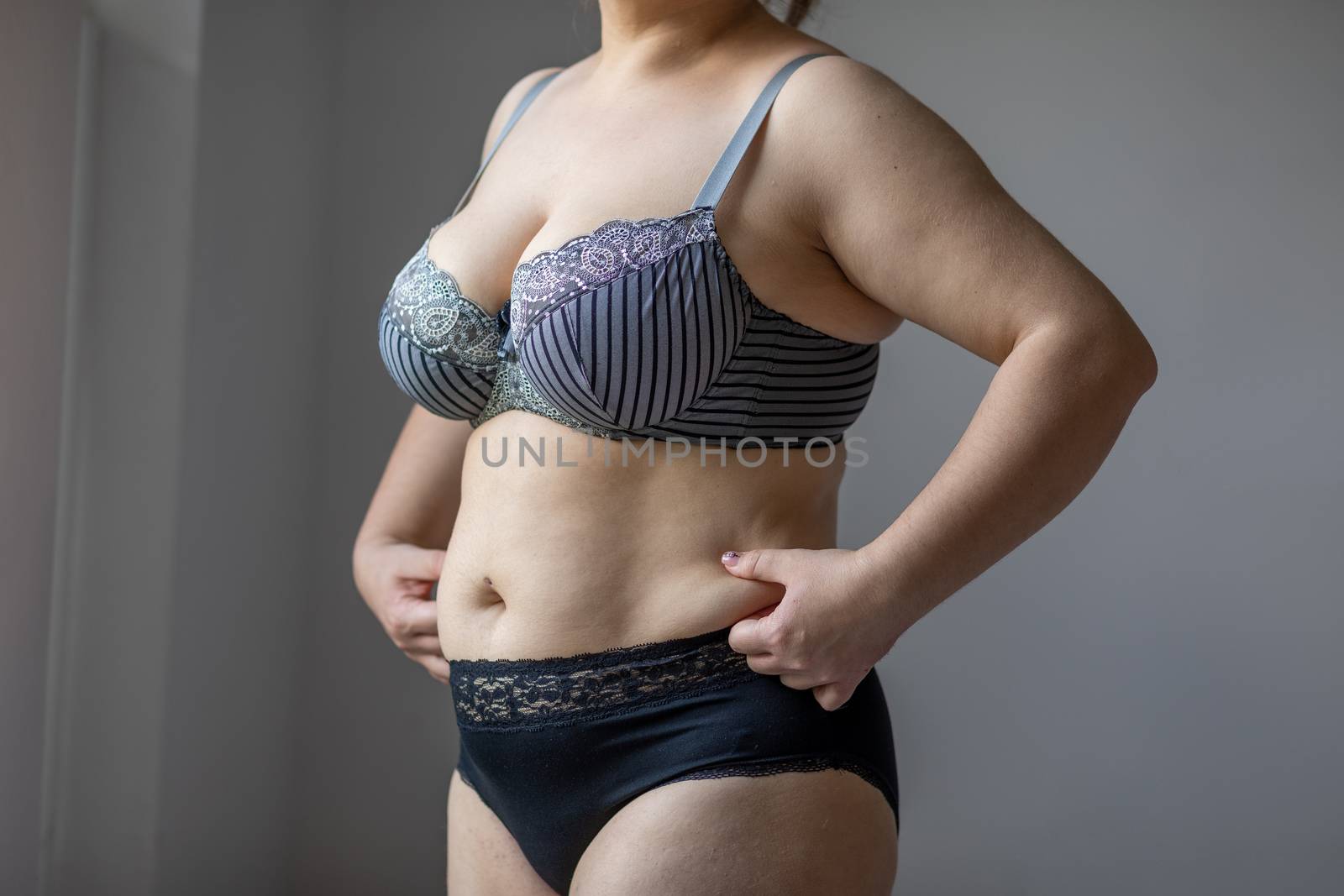 Woman Real Body Plus size Model in lingerie posign, imperfect nonideal