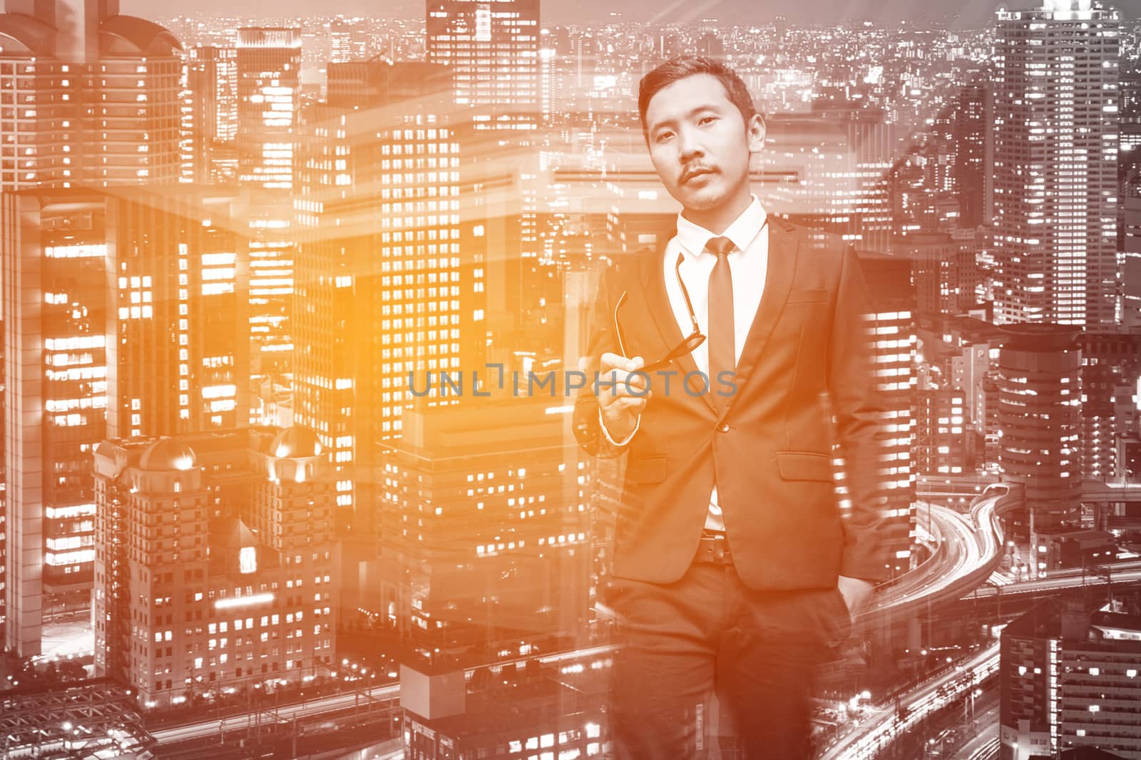 Young Asian Businessman in business background by Surasak