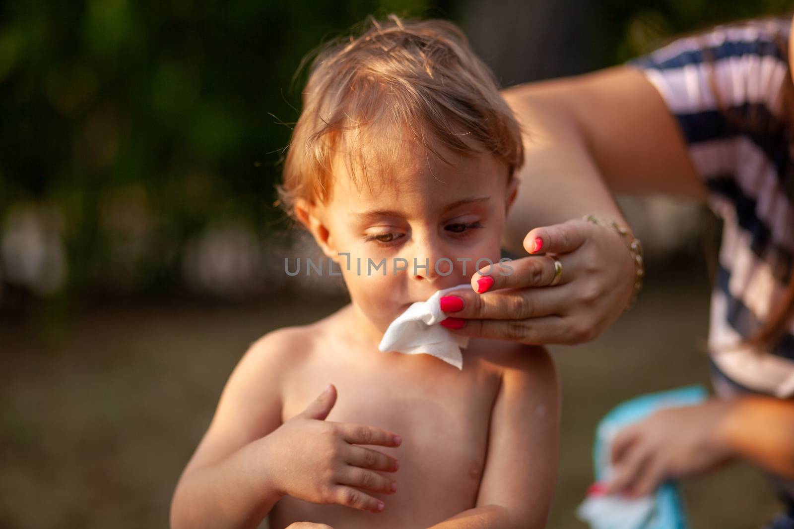 Hygiene - mom wiping the baby skin with wet wipes. Cleaning wipe, pure, clean, tissue, outdoor