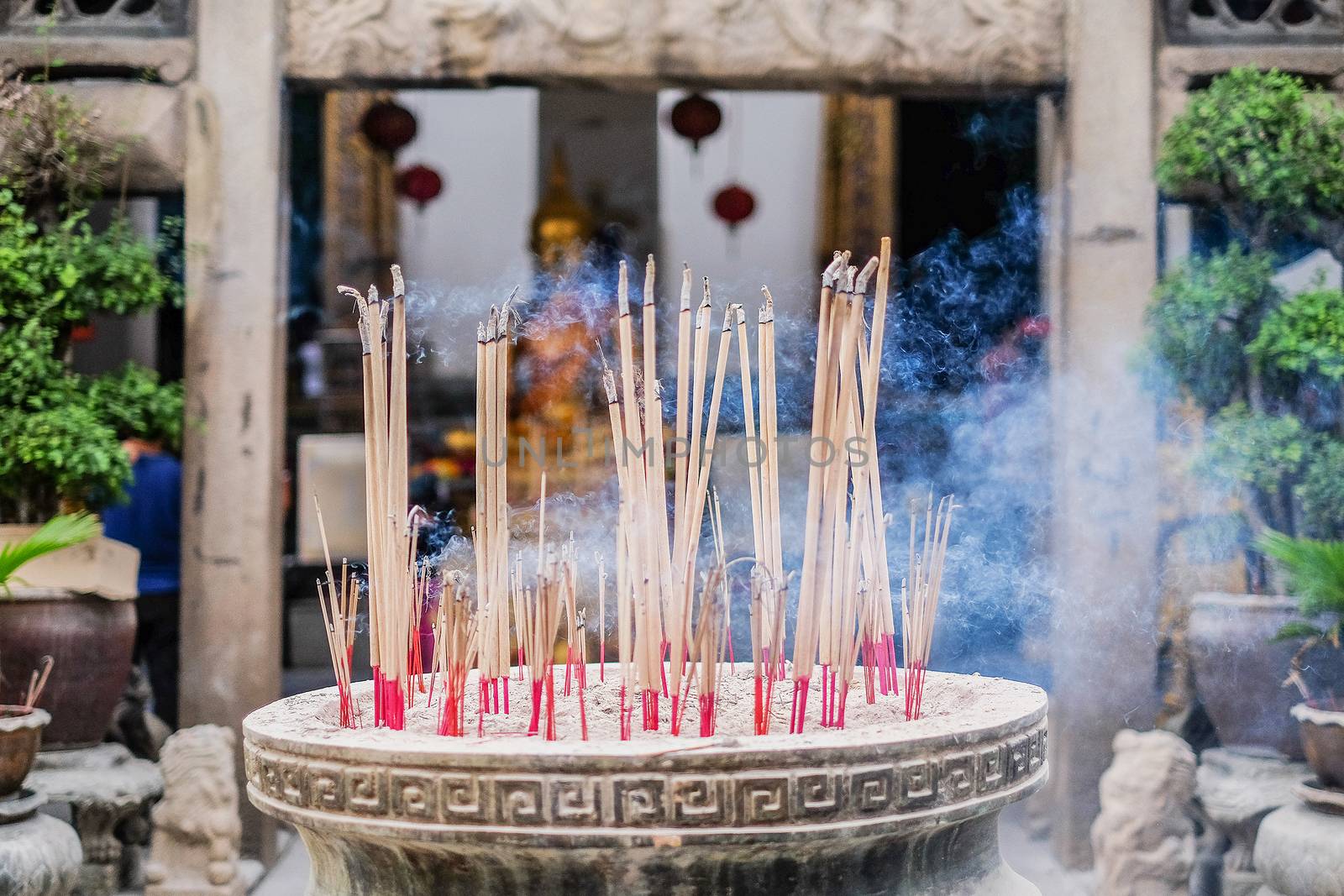 Incense sticks in ashes bucket in Temple Thialand
 by Surasak
