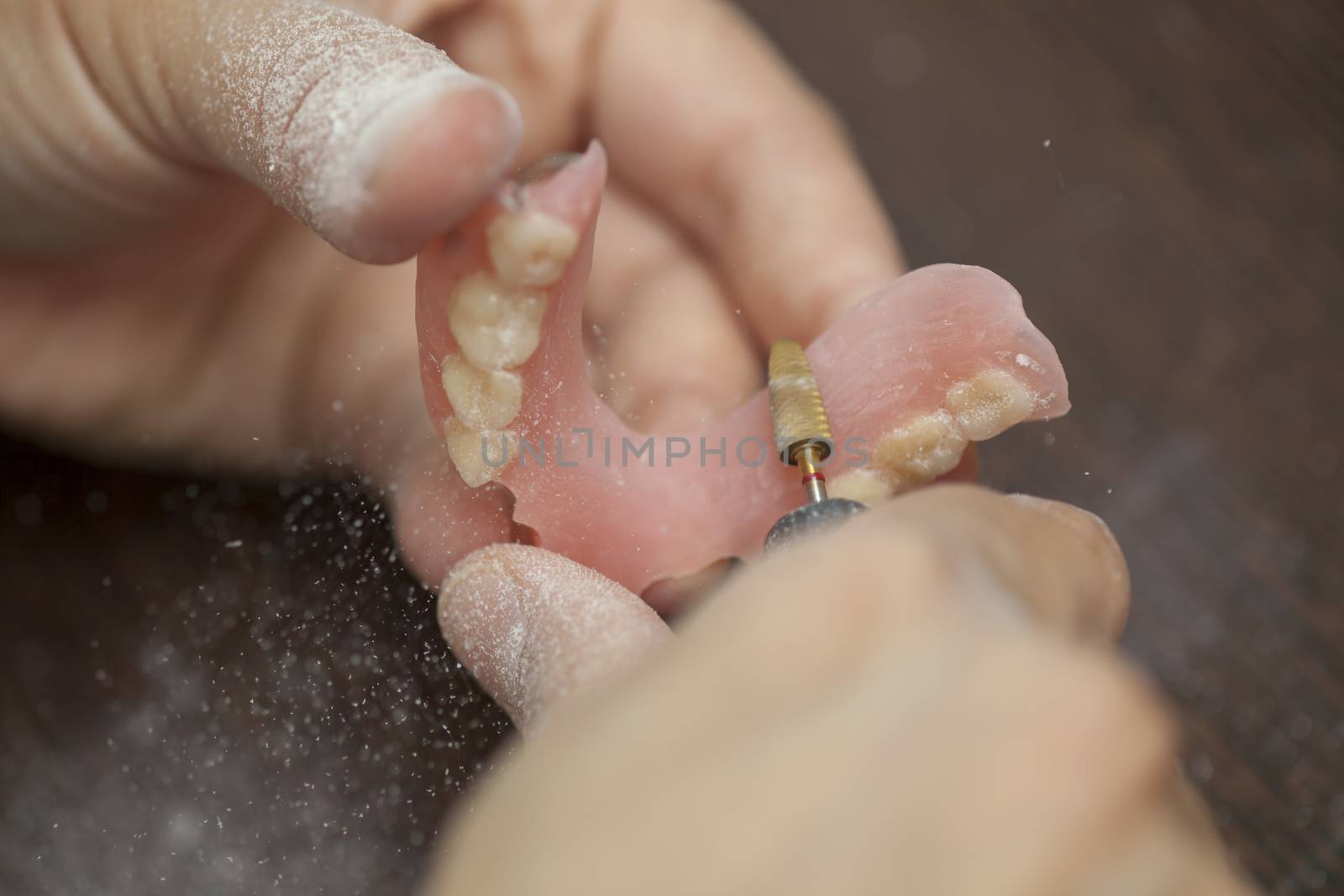 Technician make denture prothesis in dental laboratory by adamr