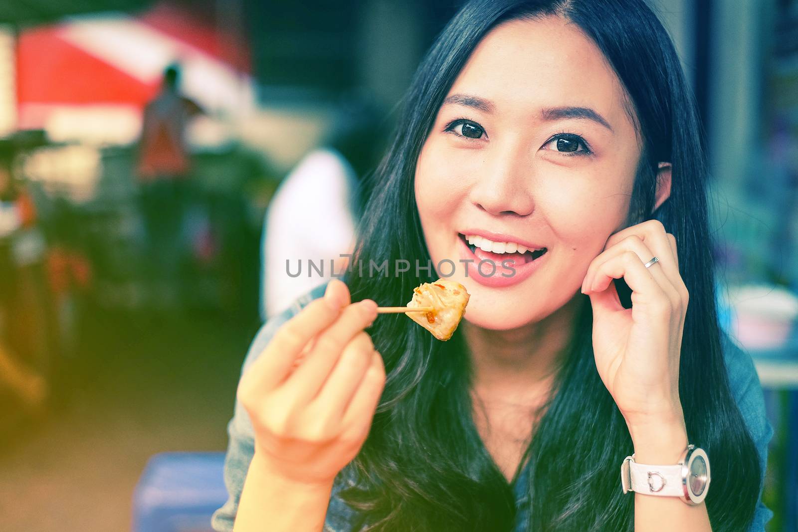 Woman eating Chinese Shanghainese steamed dumpling buns  by Surasak