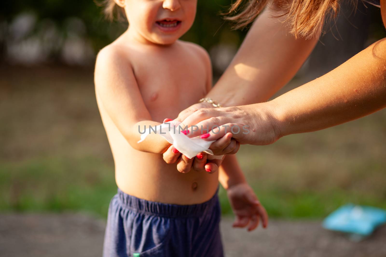 Hygiene - mom wiping the baby hands with wet wipes. Cleaning wipe, pure, clean, outdoor