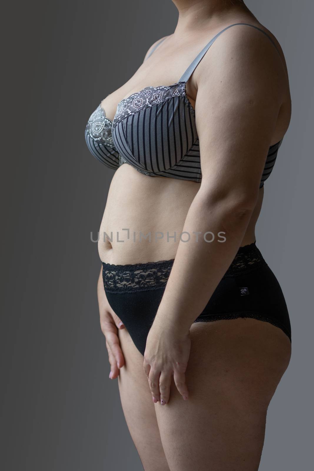 Woman Real Body Plus size Model in lingerie posign, imperfect nonideal