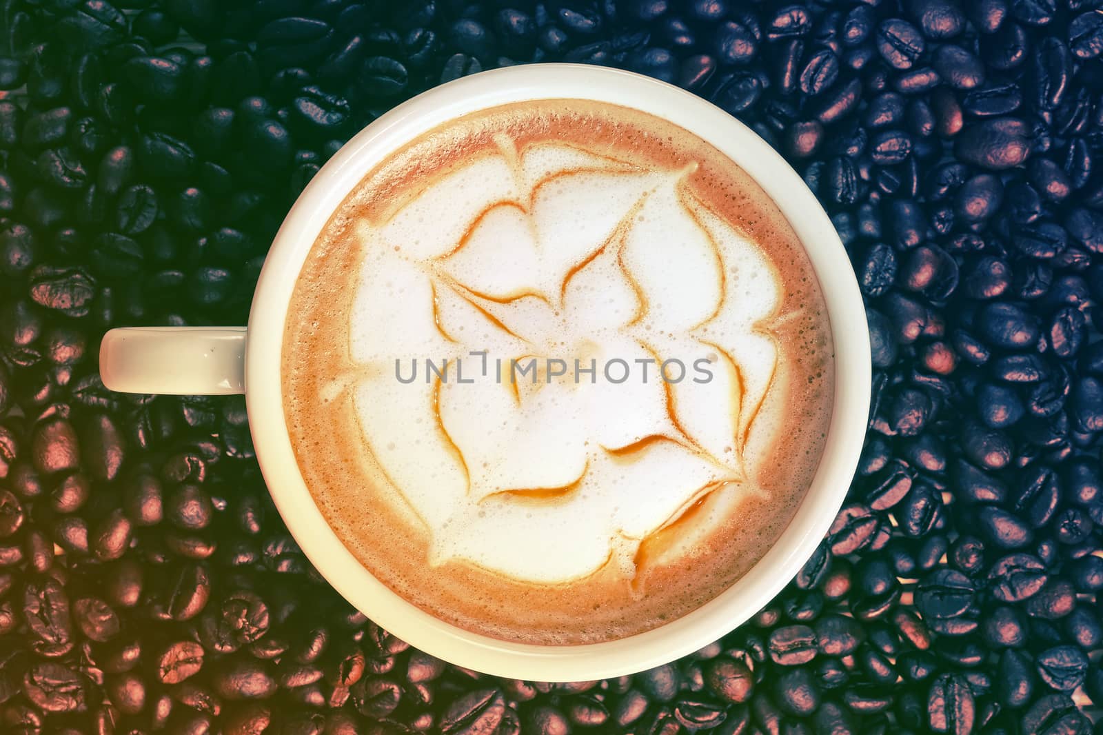 Capucino art coffee on Coffee beans background by Surasak