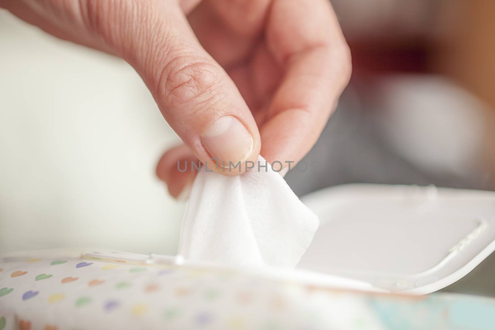 Hand picked a wet wipes in package box, Wet wipes in a woman's hand