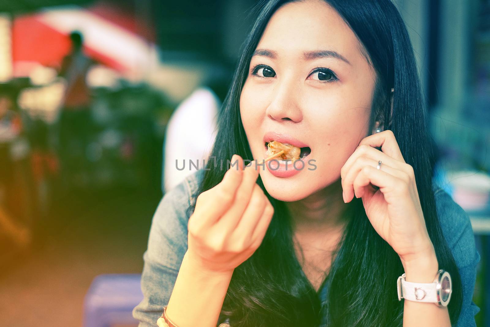 Woman eating Chinese Shanghainese steamed dumpling buns  by Surasak