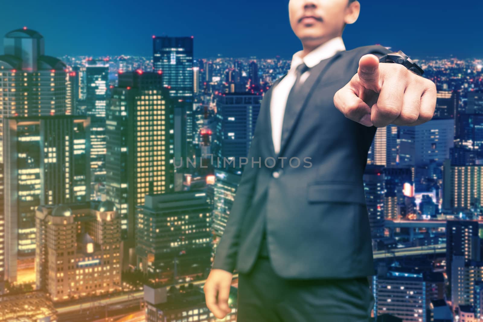 man in suit on a building business wall background
