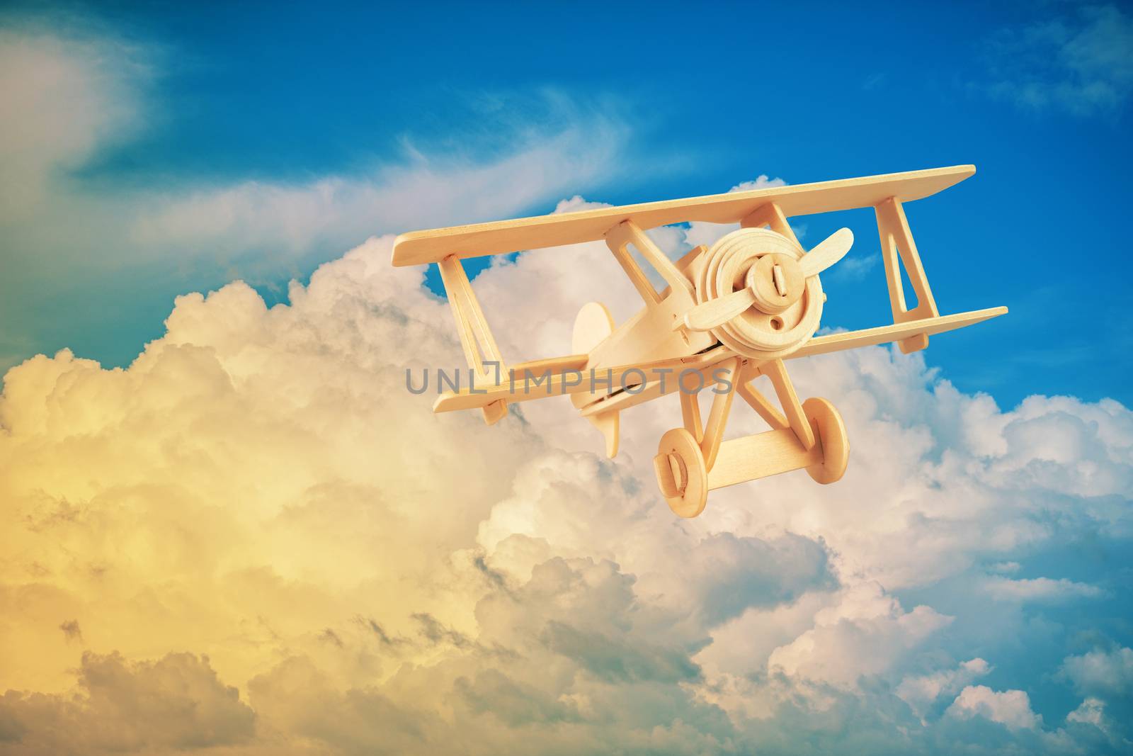 Wood airplane on the blue sky by Surasak