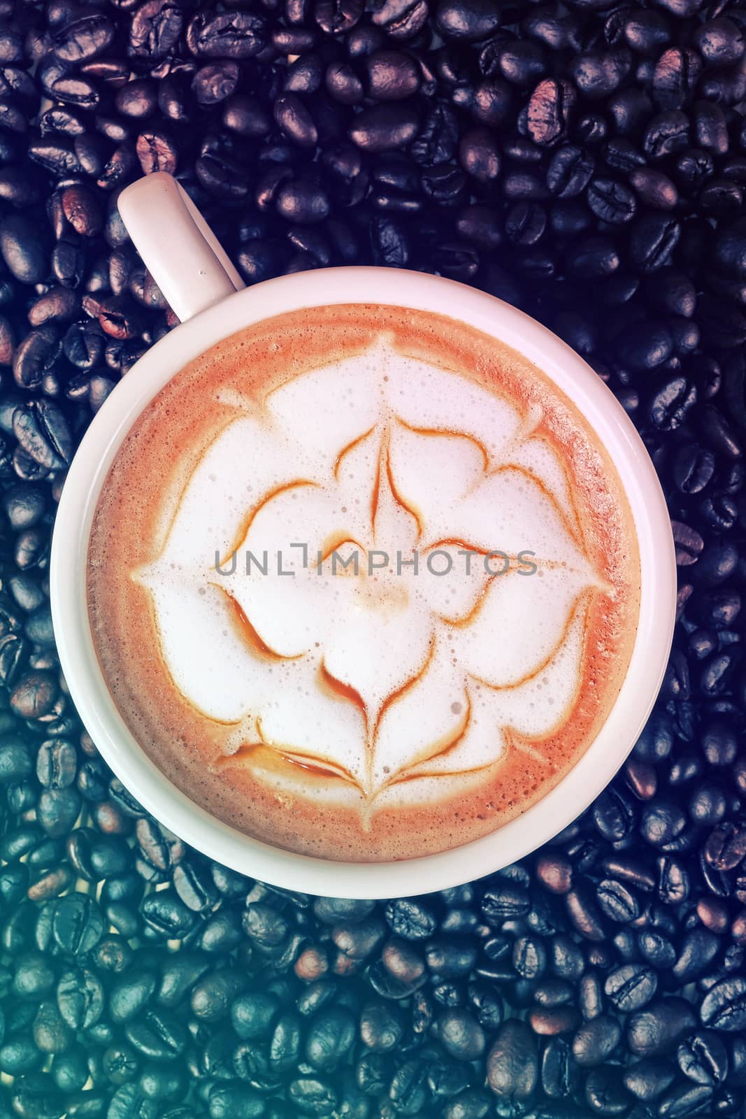 Capucino art coffee on Coffee beans background by Surasak
