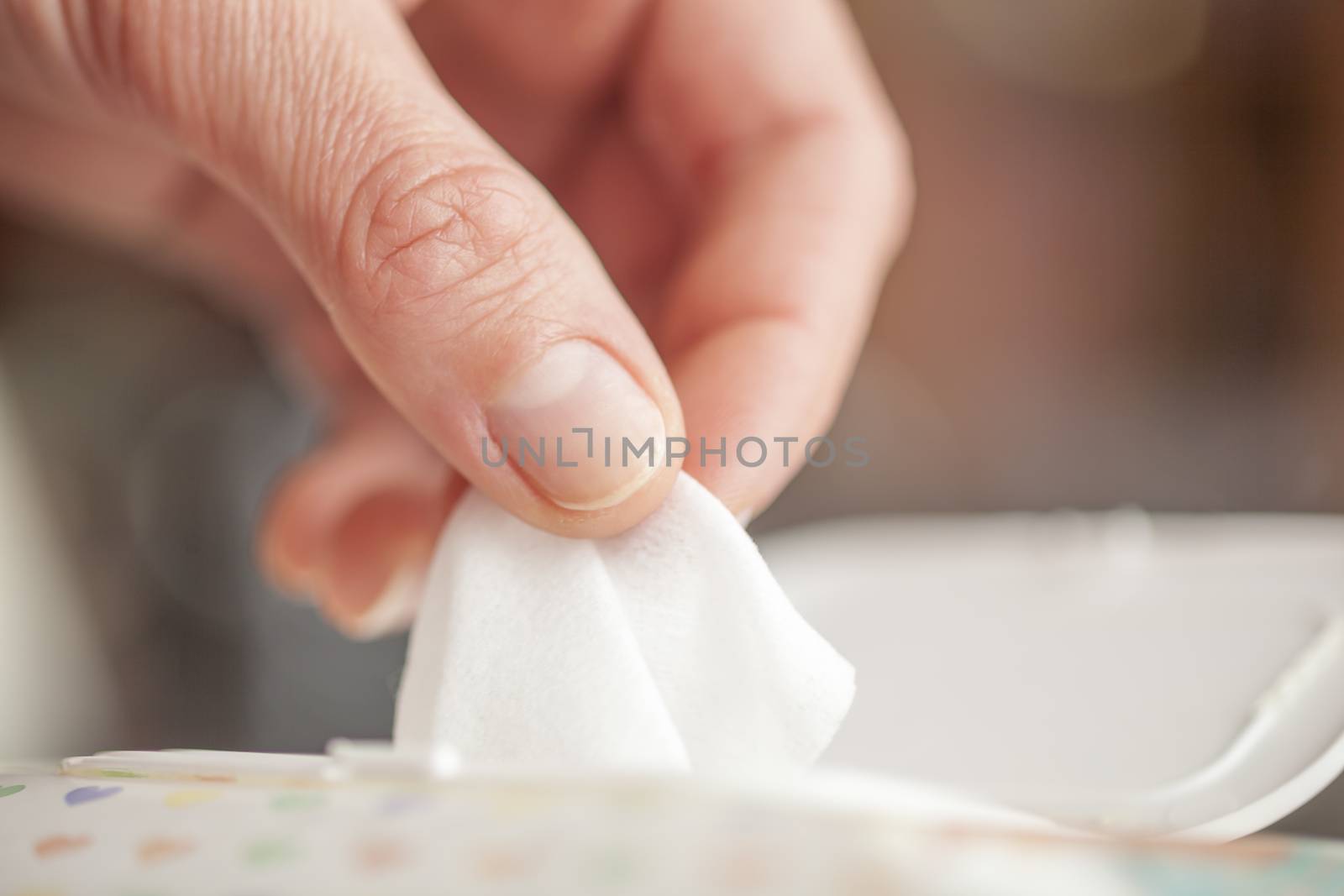 Hand picked a wet wipes in package box, Wet wipes in a woman's hand